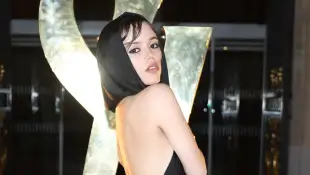 Jenna Ortega in a black silk dress with a open back at the Yves Saint Laurent fashion show