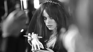 Jenna Ortega and mock hands "Thing" on the red carpet at a "Wednesday" event in November 2022.