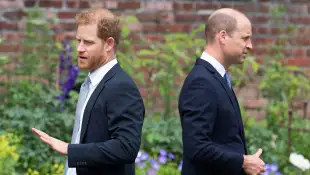 Prince Harry and Prince William stand with their backs to each other