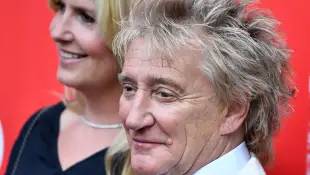 Rod Stewart and Penny Lancaster pose together at an event