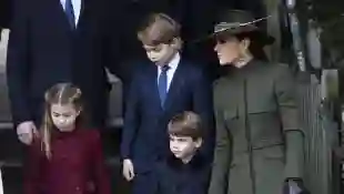 Princess Charotte, Prince George, Prince Louis and Duchess Kate walk side by side in late December 2022