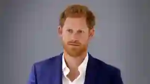 Prince Harry stands against a gray background in September 2017