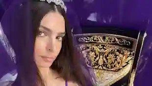 Emily Ratajkowski in a purple Versace outfit reminiscent of the look from the Netflix series Wednesday