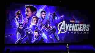 Disney Executive Cathleen Taff speaks in front of the Avengers movie poster during the 2019 CinemaCon presentation.