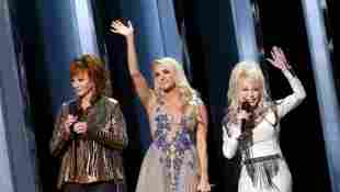 Reba McEntire, Carrie Underwood, Dolly Parton speak onstage during the 53rd annual CMA Awards at the Music City Center on November 13, 2019