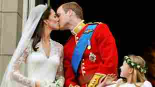 Prince William and Duchess Kate kiss on the balcony of Buckingham Palace