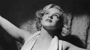 circa 1952: Portrait of American actor Marilyn Monroe (1926 - 1962) wearing a lowcut halter top on a carpet.