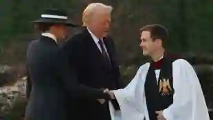 Melania Trump and Donald Trump with Rev. Robert W. Fisher
