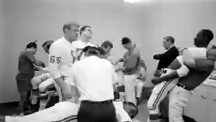 In  the  locker  room,  various  members  of  the  Kansas  City  Chiefs  football  team  are  massag