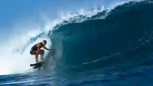 Tamayo Perry Surfing the Tube at Pipeline, Hawaii, Pro surfer, Tamayo Perry, rides a blue,tubing, wave while surfing at