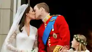 Prince William and Duchess Kate kiss on the balcony of Buckingham Palace