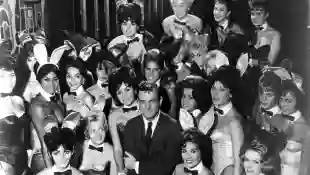 Millionaire publisher of Playboy magazine Hugh Hefner poses with a bevy of bunny girls at one of America's chain of Playboy clubs.