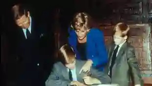 Princess Diana, Prince William, Prince Harry, and Prince Charles at Eton College in 1990.