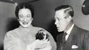 The Duke and Duchess of Windsor with their three-month-old pug terrier Disraeli in Italy, 1965.