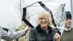 Camilla has umbrella problems in 2013 while visiting Wiltshire