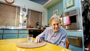 Julia Child sits in her kitchen after being moved