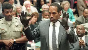 O.J. Simpson shows the jury a new pair of Aris ext