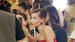 Hailey Bieber attends the Krispy Kreme 49th store to launch Strawberry Glaze doughnut tie-in with her make-up line. Feat