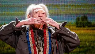 Syndication: The Indianapolis Star Willie Nelson pauses while leaving the stage after his performance to gaze upon the s