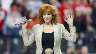 Country music icon and Grammy Award winner Reba McEntire sings the national anthem during the first quarter of Super Bow