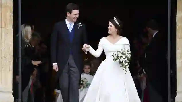 Jack Brooksbank and his wife Princess Eugenie exiting St. George's Chapel.