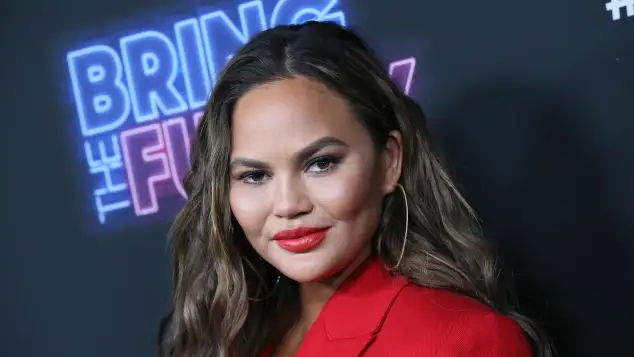 Chrissy Teigen Wears VERY Low-Cut Dress In Daring New Photo