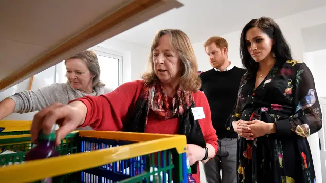 Duchess Meghan and Prince Harry helping at the One25 Charity