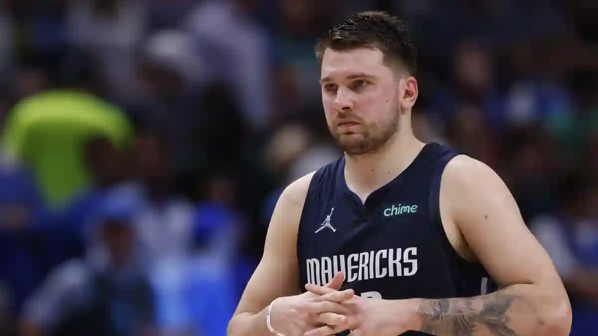 Luka Dončić tattoo tattoos left arm forearm Doncic closeup eagle tiger eye of god latin quote palm leaves number