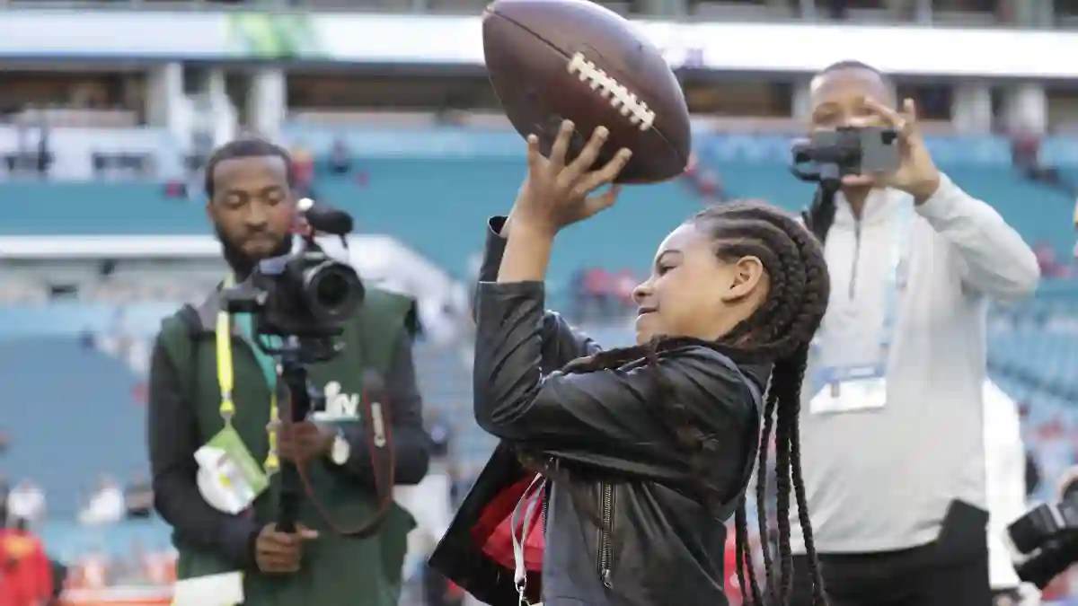 Jay-Z and Beyonc} s daughter Blue Ivy Carter warms up with a football before Super Bowl LIV at the Hard Rock Stadium in