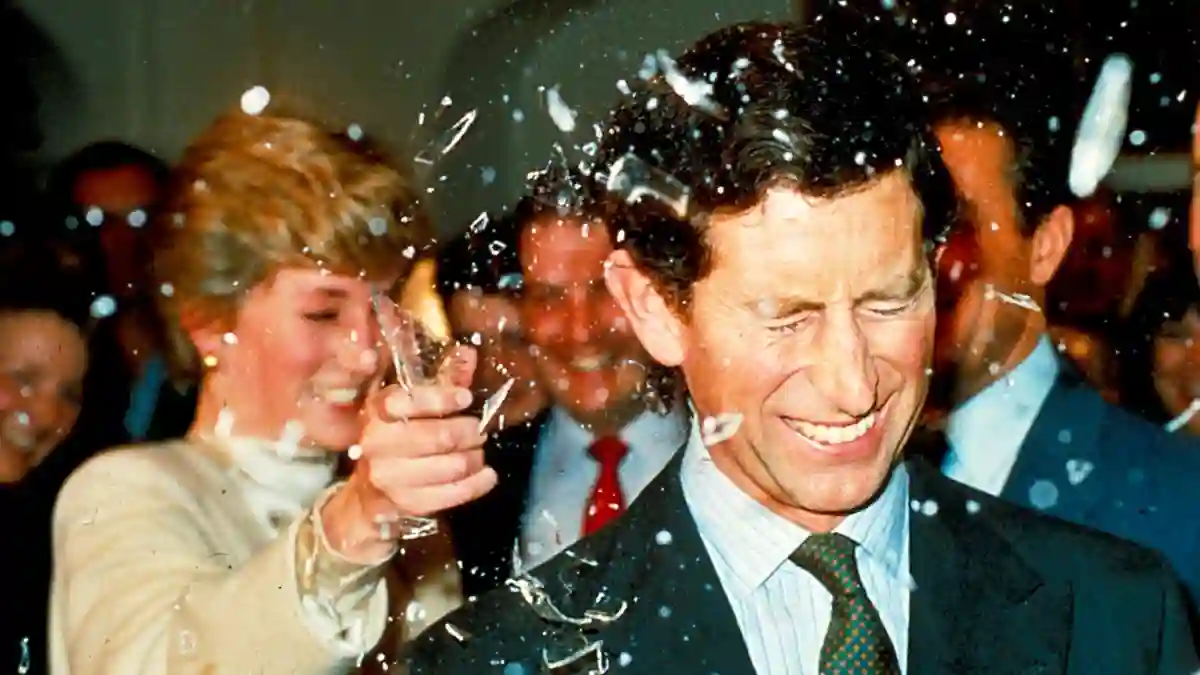 Princess Diana breaks a sugar glass bottle over her husband's head at Pinewood Studios to watch the making of the latest James Bond films on 11 December 1986.