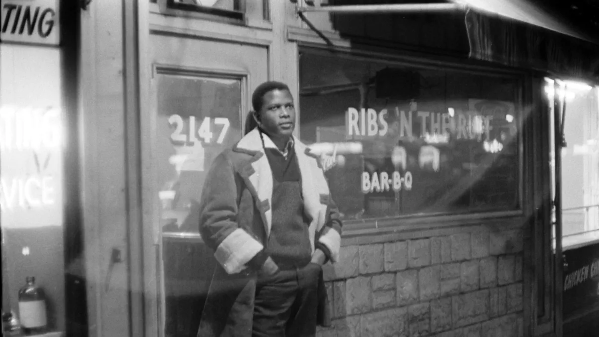 Portrait  of  Sidney  Poitier  standing  in  front  of  his  barbecue  restaurant  'Ribs  in  the  R