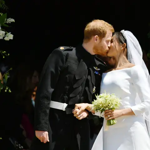 Prince Harry and Meghan Markle kiss on the steps of St George's Chapel in Windsor Castle after their wedding in St George's Chapel at Windsor Castle on May 19, 2018.