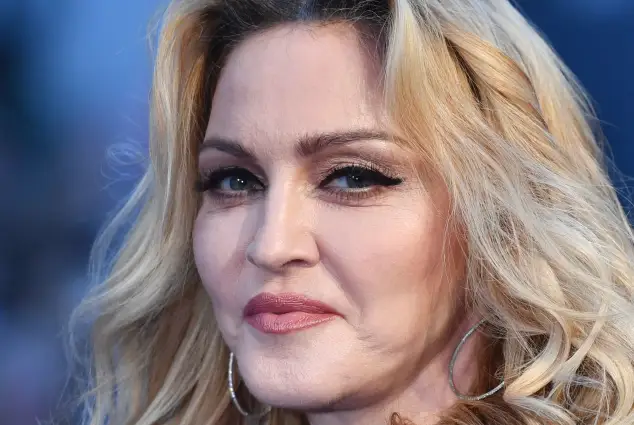 Madonna poses arriving on the carpet to attend a special screening of the film 