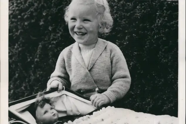 Princess Anne with her doll on the grounds of Balmoral.