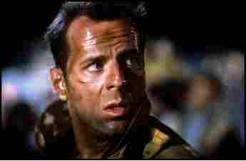 Bruce Willis as "John McClane" in Die Hard.