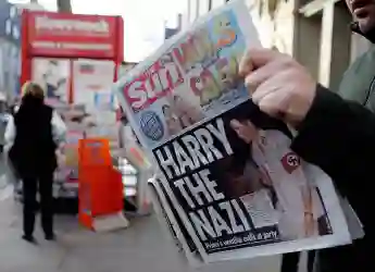 A man reads the newspaper "The Sun" in L