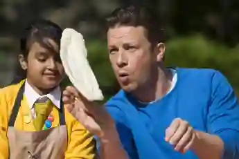 Jamie Oliver with a child at Food Revolution Day 2014 in London, England.