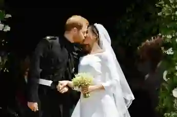 Prince Harry and Meghan Markle kiss on the steps of St George's Chapel in Windsor Castle after their wedding in St George's Chapel at Windsor Castle on May 19, 2018.