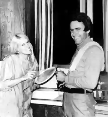 Ted (Theodore) Bundy helps Carol Bartholomew clean up dishes from a 1975 birthday party