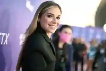 Christina Perri smiles for the camera on the red carpet