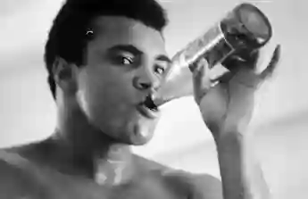 A  close-up  of  professional  boxer  Muhammad  Ali  having  a  drink  during  his  training  for  t