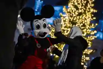 Christmas tree lit up in Lviv LVIV, UKRAINE - DECEMBER 5, 2023 - An entertainer in the costume of Mickey Mouse performs