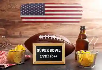 January 27, 2024: The 58th Super Bowl, football surrounded by snacks and beer and USA flag with a plaque reading Super B