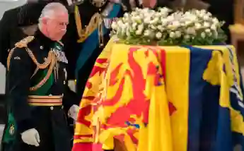 King Charles III in front of the Queen's coffin