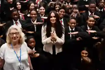 Duchess Meghan poses with school children during a visit to Robert Clack School in Dagenham, March 6, 2020.