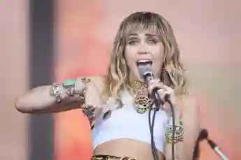 Miley Cyrus takes the stage and sings in June 2019.