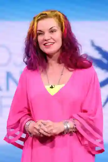 Pauley Perrette in a pink dress and colorful hair