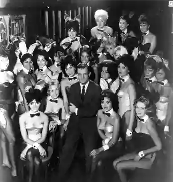 Millionaire publisher of Playboy magazine Hugh Hefner poses with a bevy of bunny girls at one of America's chain of Playboy clubs.