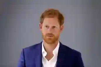 Prince Harry stands against a gray background in September 2017