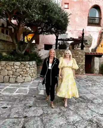 Rebel Wilson and her friend Ramona walk the streets of Italy holding hands